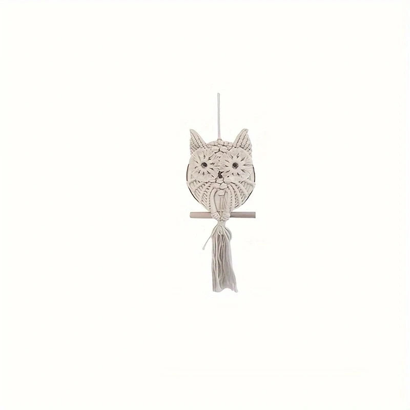 Decorative owl-shaped ornament with tassel on a white background