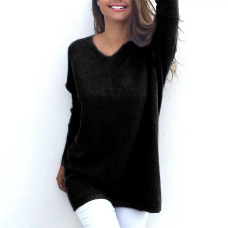 Person wearing a black sweater against a white background