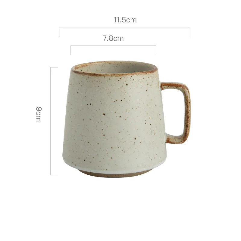 Speckled ceramic mug with dimensions on a white background
