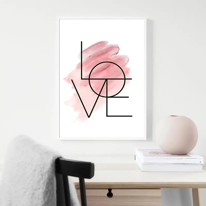 Framed abstract art print with 'LOVE' design on a wall above a table.