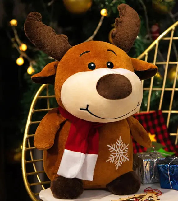 Plush reindeer toy with a red scarf in a festive setting with lights and presents.