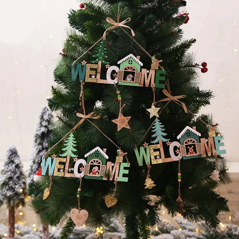 Decorative Christmas tree with 'WELCOME' ornaments and snow-covered trees in the background