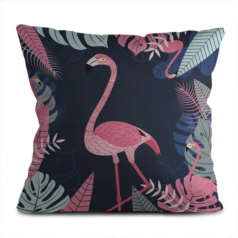 Decorative pillow with pink flamingo and tropical leaves on a dark background