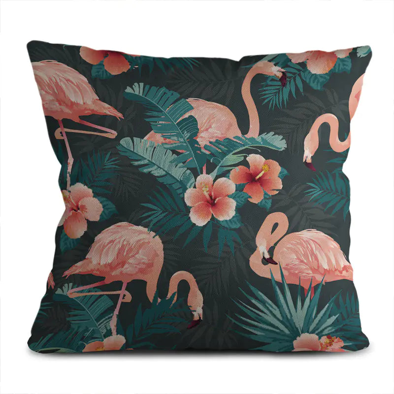 Decorative pillow with flamingo and tropical leaf pattern on a dark background